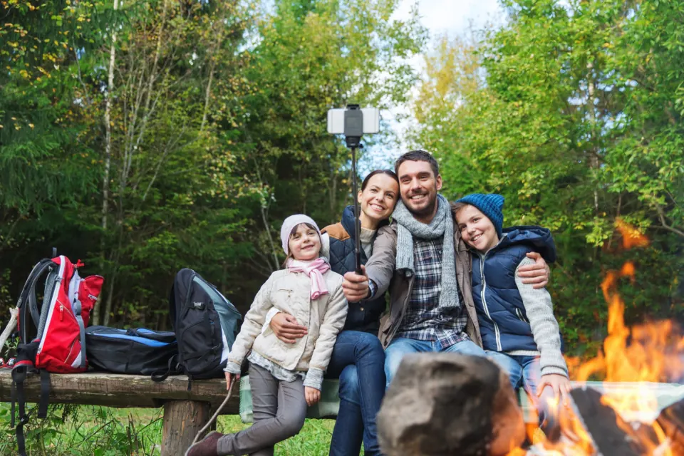 A group selfie at the campfire